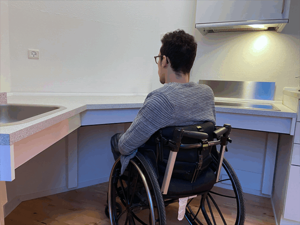 Alexander using accessible corner kitchen worktop from wheelchair
