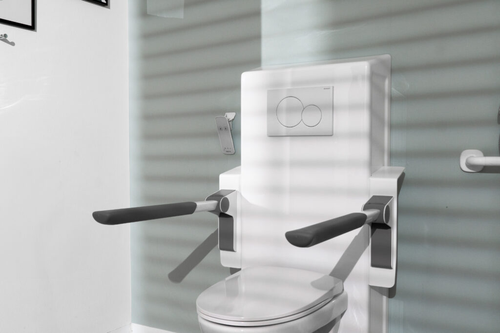 Front view of Ropox toilet support arms extended horizontally on either side of a wall-hung toilet
