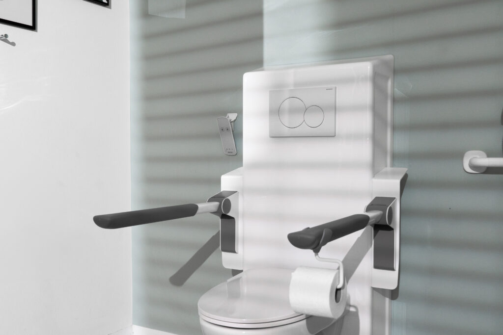 Toilet lifter with support arms in lowered position showing toilet roll holder