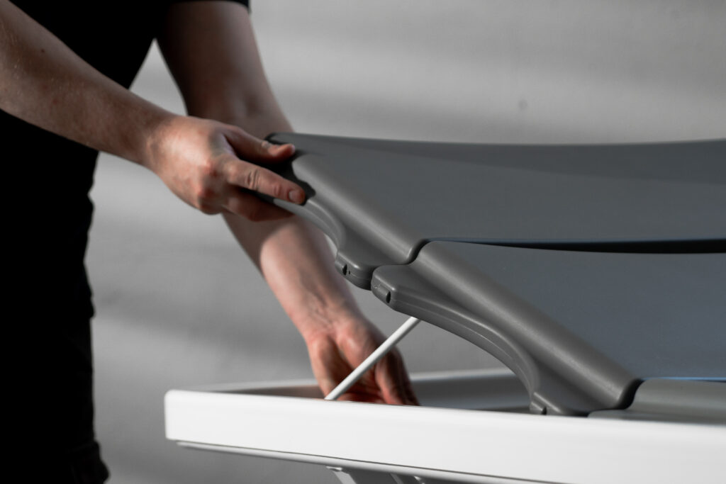 Caregiver removing the soft slat mattress from a shower stretcher