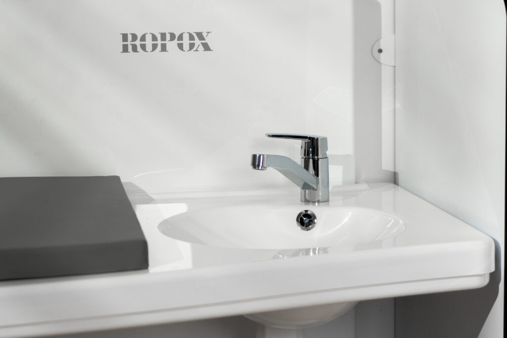 Close-up of integrated sink and tap on a Ropox daycare changing table
