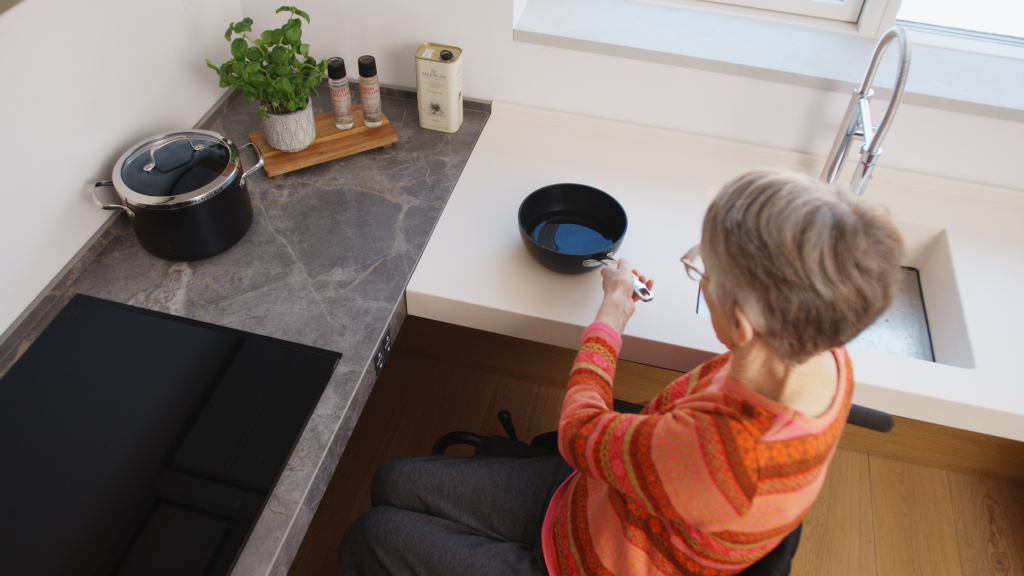 Wheelchair user in a hieght adjustable kitchen